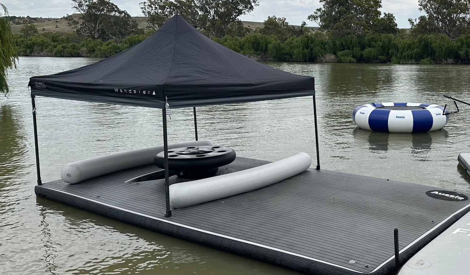 People relaxing on an Aussie Floats inflatable houseboat deck extension