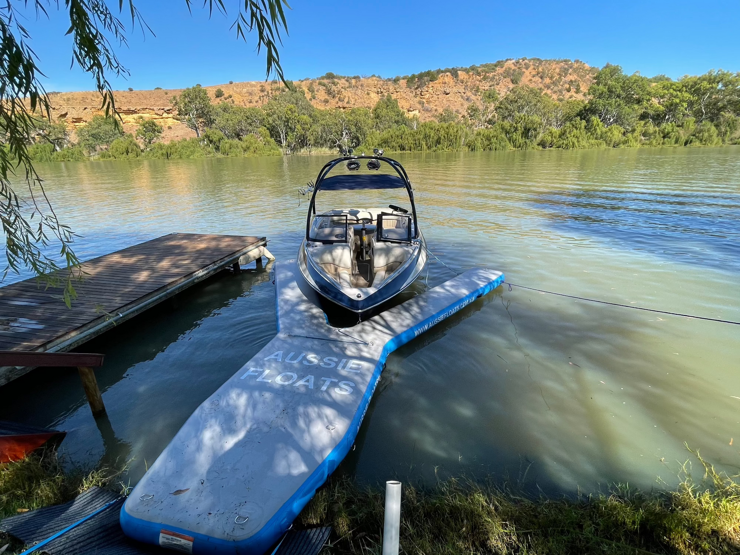 Custom coloured Aussie Floats inflatable pontoon on the water