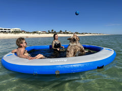 Person relaxing on an Aussie Floats Lily Pad water hammock
