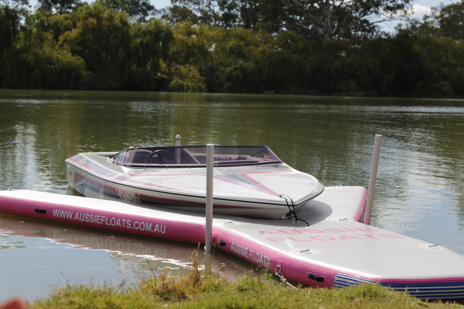 Aussie Floats custom coloured inflatable pontoon moored beside a boat