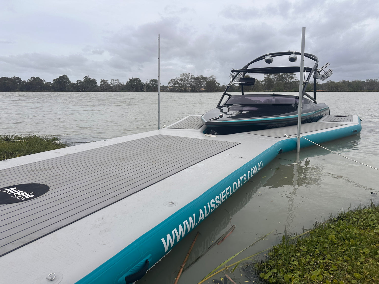 Aussie Floats Walk Up Series inflatable pontoon beside a ski boat